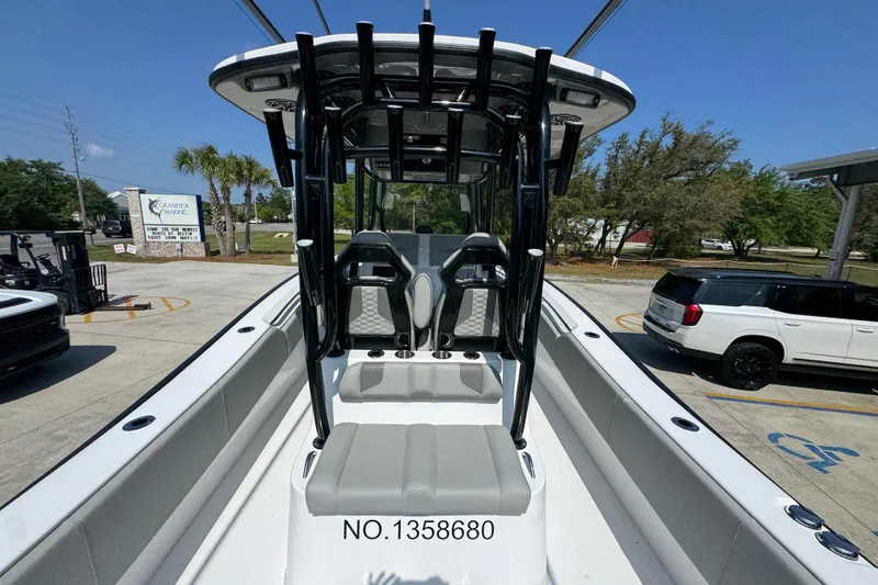 Slide: The Image of 2025 Cape Horn 32 XS boat with sleek seating and modern design in a parking lot. - 37