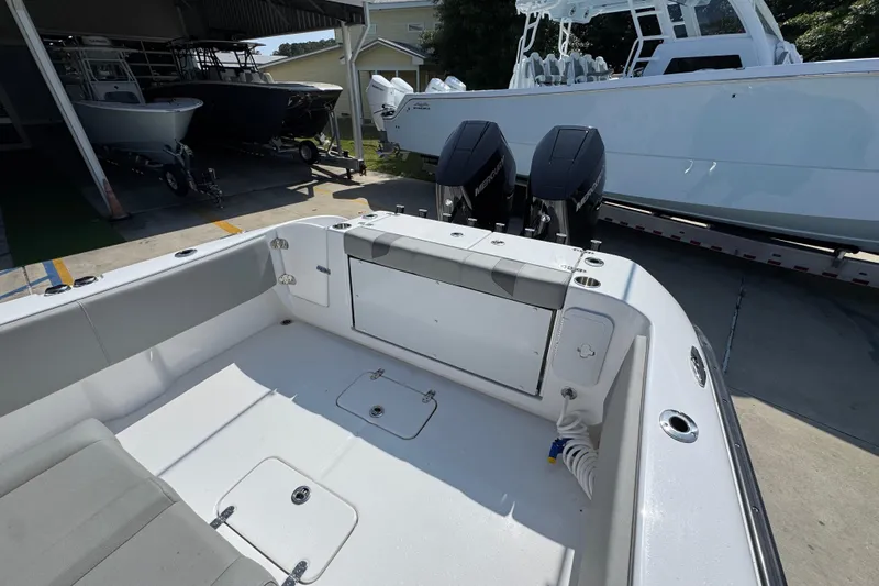 Slide: The Image of 2025 Cape Horn 32 XS boat interior with dual Mercury engines in a marina setting. - 39