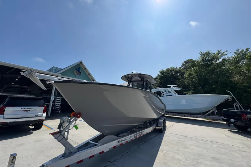 Slide: The Image of 2025 Cape Horn 32 XS boat on trailer in sunny outdoor setting. - 4