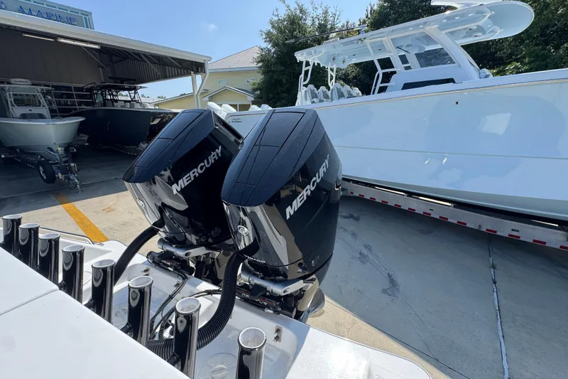Slide: The Image of 2025 Cape Horn 32 XS boat with dual Mercury engines in a marina setting. - 42