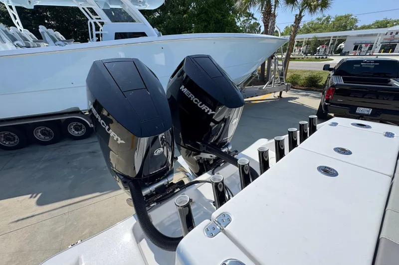 Slide: The Image of 2025 Cape Horn 32 XS boat with dual Mercury engines, parked on a trailer. - 43