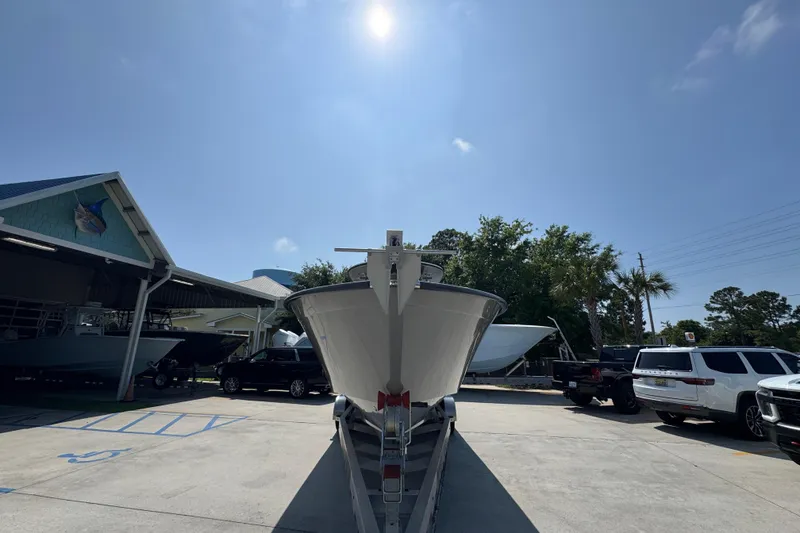 Slide: The Image of 2025 Cape Horn 32 XS boat on trailer under clear blue sky. - 6