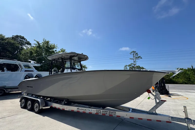 Slide: The Image of 2025 Cape Horn 32 XS boat on trailer under clear blue sky. - 8