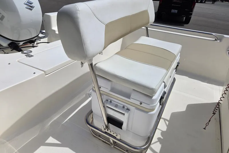 Slide: The Image of Bulls Bay 2000 boat seat with cooler, 2023 model, featuring white and beige upholstery. - 11