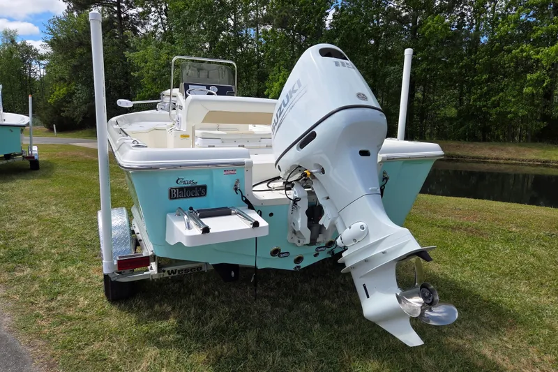 Slide: The Image of 2023 Bulls Bay 2000 boat with Suzuki outboard motor on a grassy area. - 3