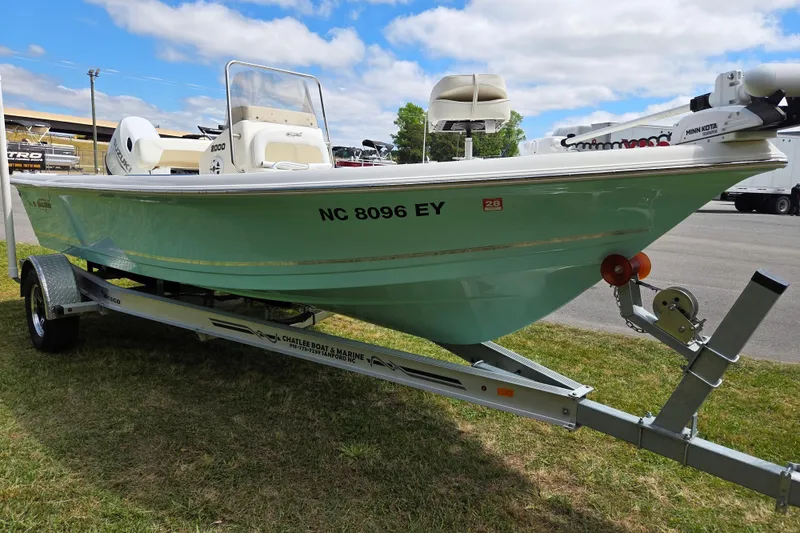 Slide: The Image of 2023 Bulls Bay 2000 boat on trailer, displayed outdoors under a partly cloudy sky. - 7