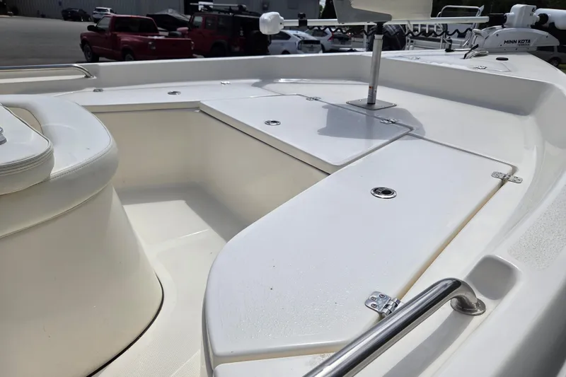 Slide: The Image of 2023 Bulls Bay 2000 boat interior with white seating and storage compartments. - 9
