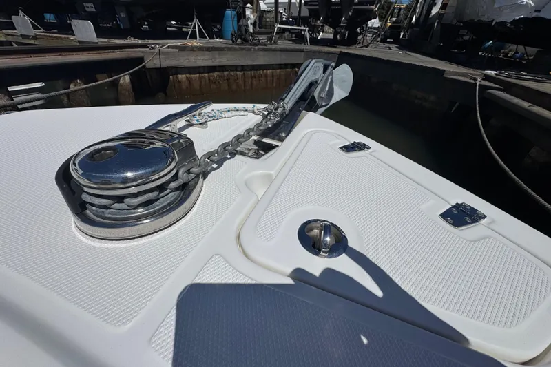 Slide: The Image of 2017 Boston Whaler 250 Outrage anchor system on deck, featuring stainless steel components. - 13