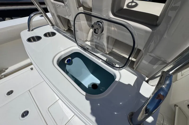 Slide: The Image of 2017 Boston Whaler 250 Outrage boat interior with livewell and cup holders. - 15