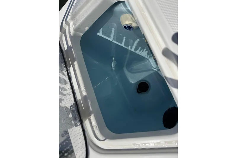 Slide: The Image of Livewell compartment on a 2017 Boston Whaler 250 Outrage boat, filled with water. - 17