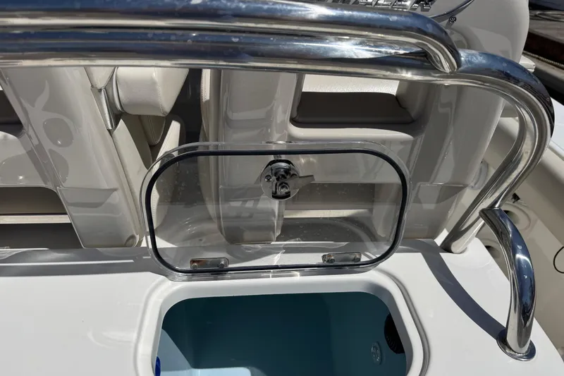 Slide: The Image of 2017 Boston Whaler 250 Outrage boat interior with stainless steel railing and storage compartment. - 18