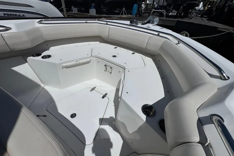 Slide: The Image of 2017 Boston Whaler 250 Outrage boat interior with cushioned seating and storage compartments. - 24