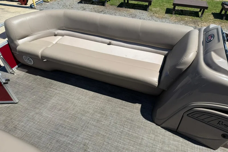 Slide: The Image of 2022 Ranger 200C boat interior with beige seating and carpeted flooring. - 10
