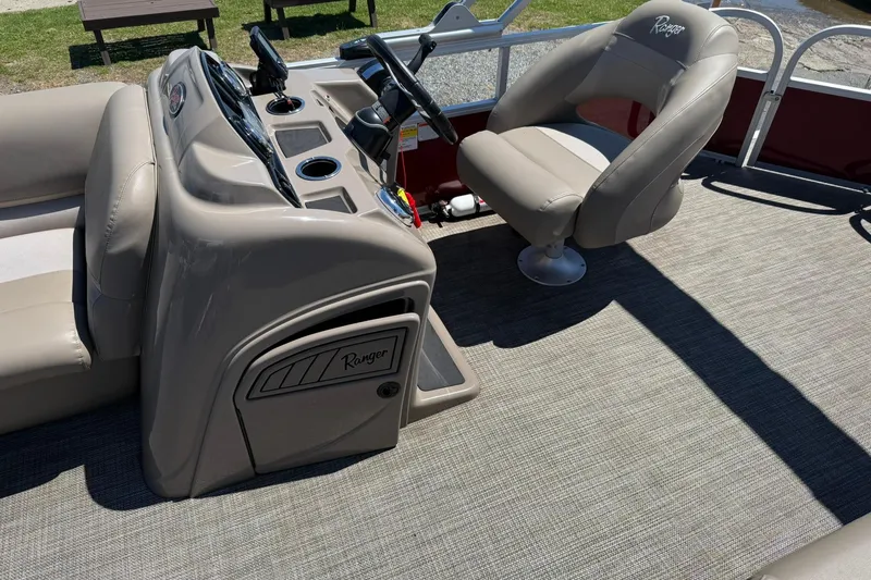 Slide: The Image of 2022 Ranger 200C boat interior with beige seating and control panel. - 11