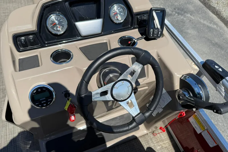 Slide: The Image of 2022 Ranger 200C boat dashboard with steering wheel and navigation controls. - 13