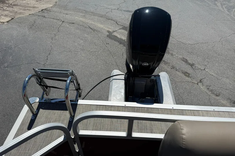 Slide: The Image of Rear view of 2022 Ranger 200C boat with motor and ladder on pavement. - 16