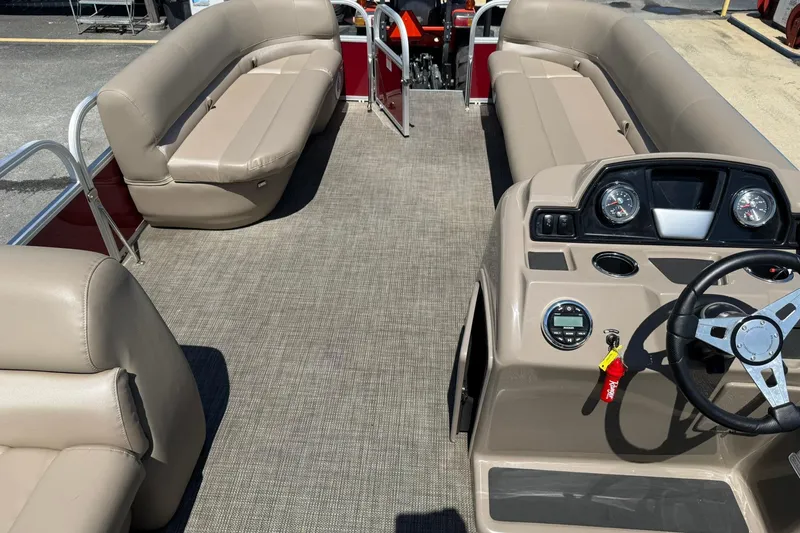 Slide: The Image of Interior of a 2022 Ranger 200C pontoon boat with beige seating and steering console. - 18