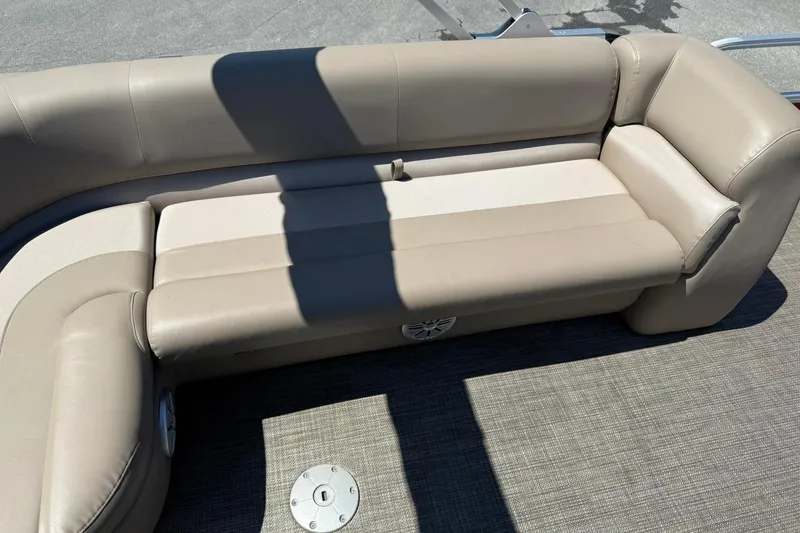Slide: The Image of Beige seating on 2022 Ranger 200C boat, featuring comfortable upholstery and integrated speaker. - 19