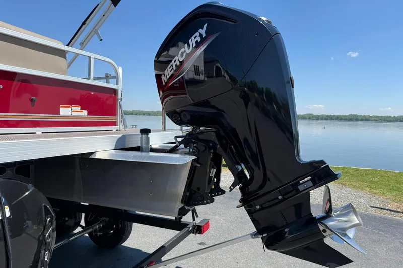 Slide: The Image of Ranger 200C 2022 boat with Mercury outboard motor by a lake. - 3