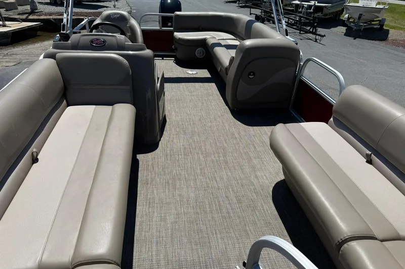 Slide: The Image of 2022 Ranger 200C pontoon boat interior with beige seating and carpeted floor. - 8