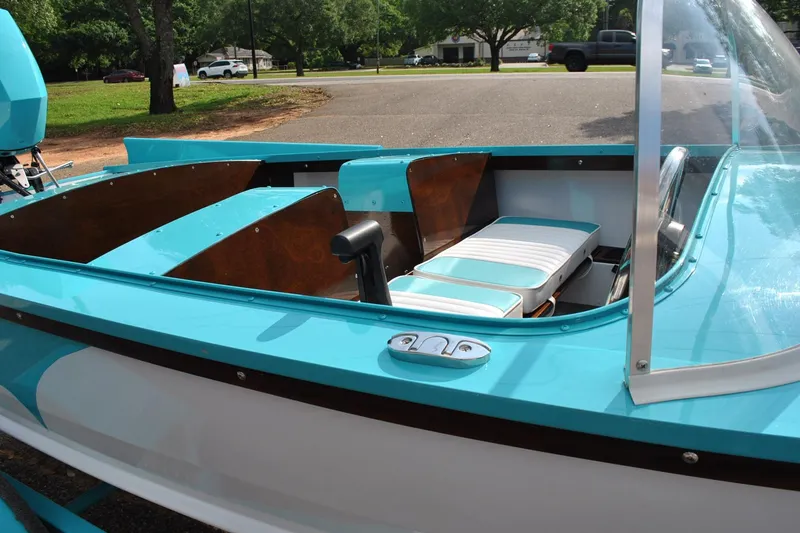 Slide: The Image of 2025 Starcraft 57 Ski Champ boat with turquoise and white interior, parked outdoors. - 10