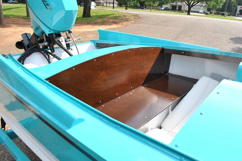 Slide: The Image of Turquoise 2025 Starcraft 57 Ski Champ boat interior with wooden accents and Mercury outboard motor. - 11