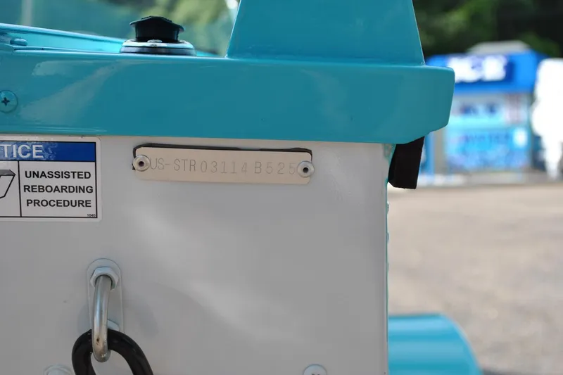 Slide: The Image of 2025 Starcraft 57 Ski Champ boat with identification plate and reboarding notice. - 16