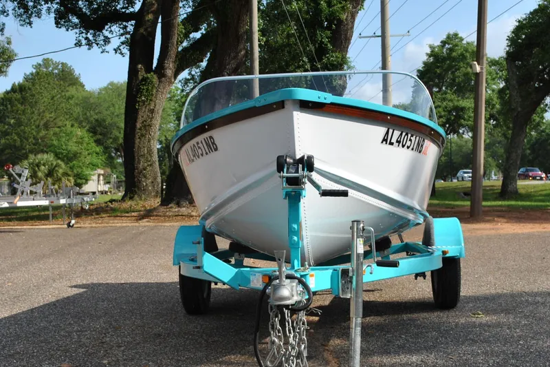 Slide: The Image of 2025 Starcraft 57 Ski Champ boat on trailer, parked outdoors. - 3