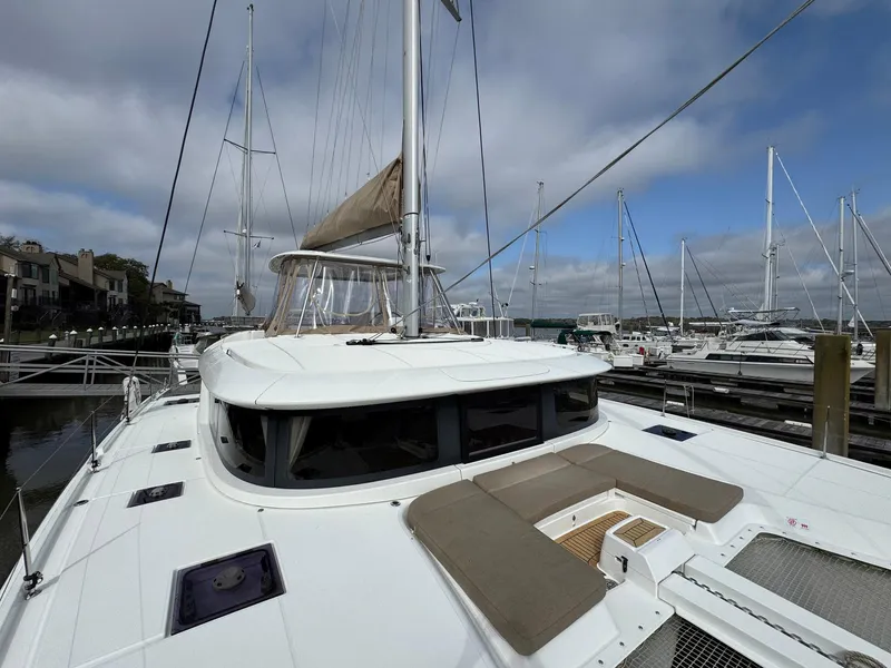 Slide: The Image of 2022 Lagoon 46 catamaran docked at marina under cloudy sky. - 10