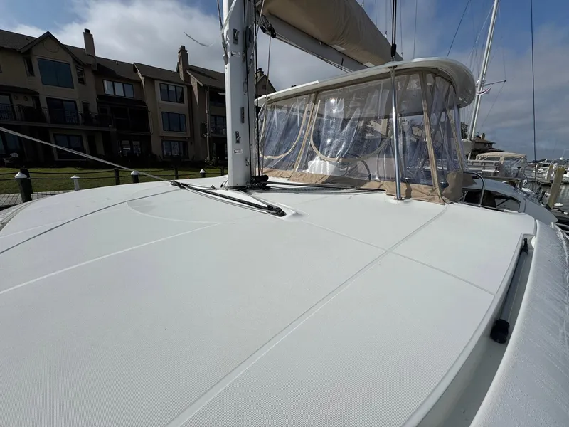 Slide: The Image of 2022 Lagoon 46 catamaran docked, showcasing sleek deck design and modern sail features. - 19