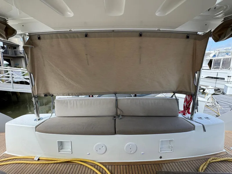 Slide: The Image of 2022 Lagoon 46 yacht with cushioned seating and privacy screen on deck. - 34