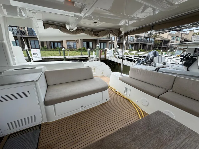Slide: The Image of 2022 Lagoon 46 catamaran with spacious seating area and modern design at a marina. - 39