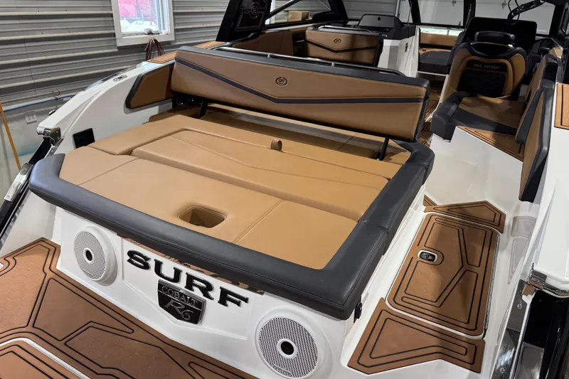 Slide: The Image of 2023 Cobalt R6 Surf boat interior with tan seating and sleek design. - 10