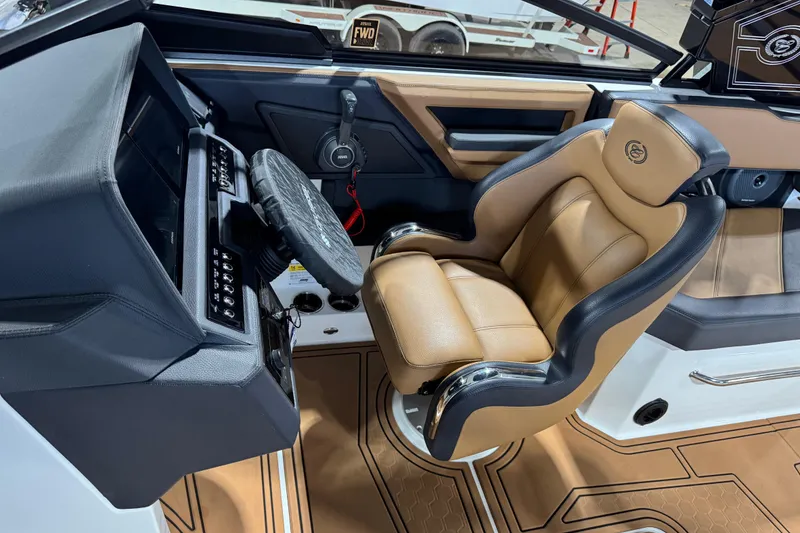 Slide: The Image of 2023 Cobalt R6 Surf boat interior with luxurious tan and black captain's seat. - 16