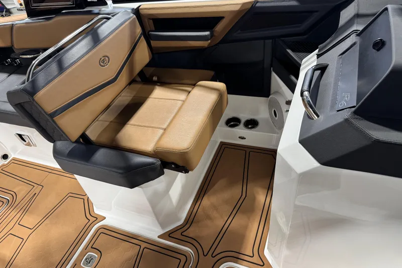 Slide: The Image of 2023 Cobalt R6 Surf boat interior with tan and black seating, modern design. - 17