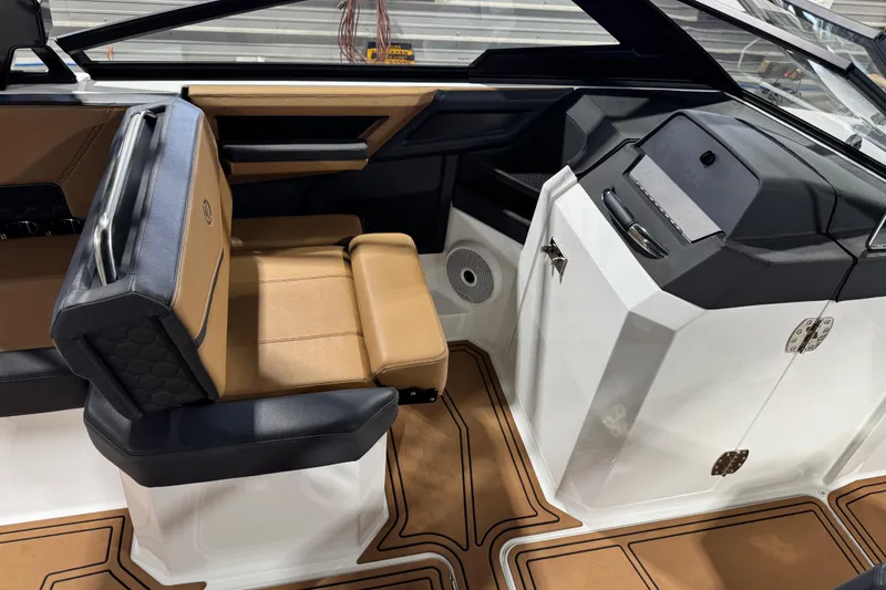 Slide: The Image of 2023 Cobalt R6 Surf boat interior with tan and black seating, modern dashboard. - 18