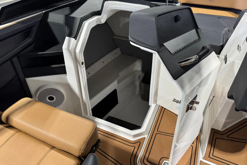 Slide: The Image of 2023 Cobalt R6 Surf boat interior with open storage compartment and tan seating. - 19