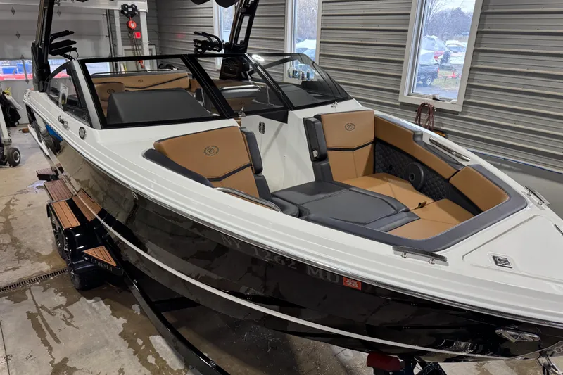 Slide: The Image of 2023 Cobalt R6 Surf boat in a garage, featuring sleek design and luxurious seating. - 4