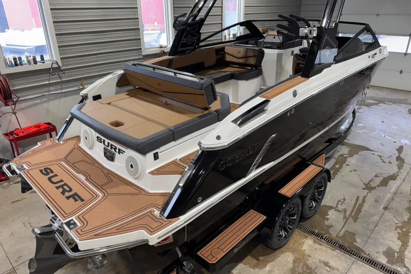 Slide: The Image of 2023 Cobalt R6 Surf boat in a garage, featuring sleek design and modern interior. - 8