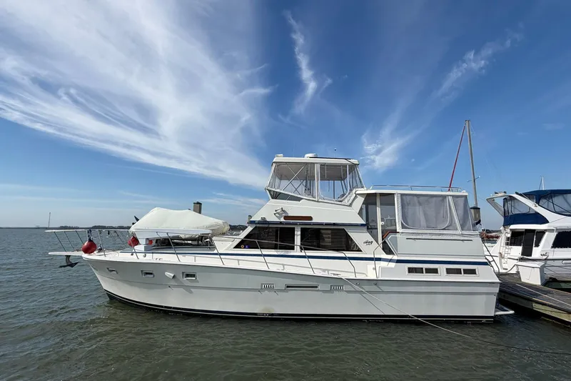 The Image of 1987 Viking 44 Motor Yacht docked under a clear blue sky. - 1