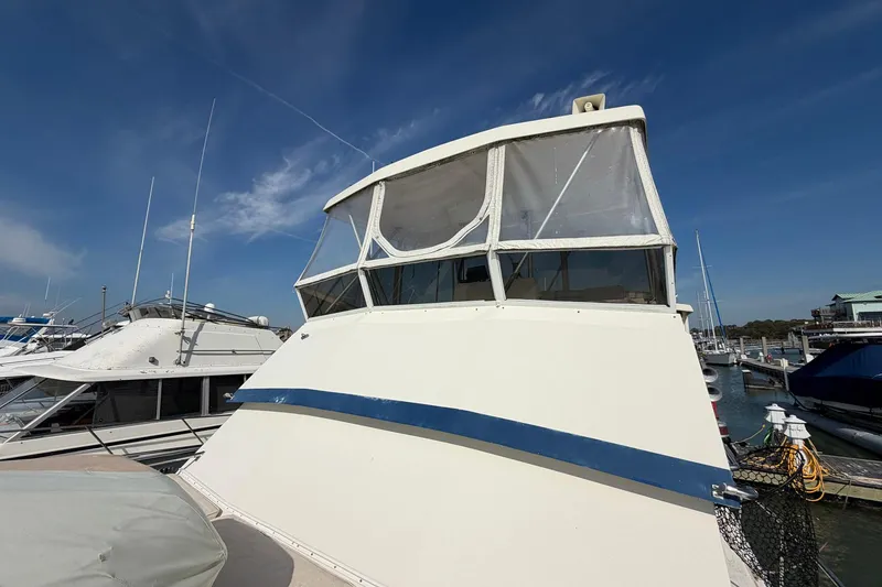 Slide: The Image of 1987 Viking 44 Motor Yacht docked at marina under clear blue sky. - 15