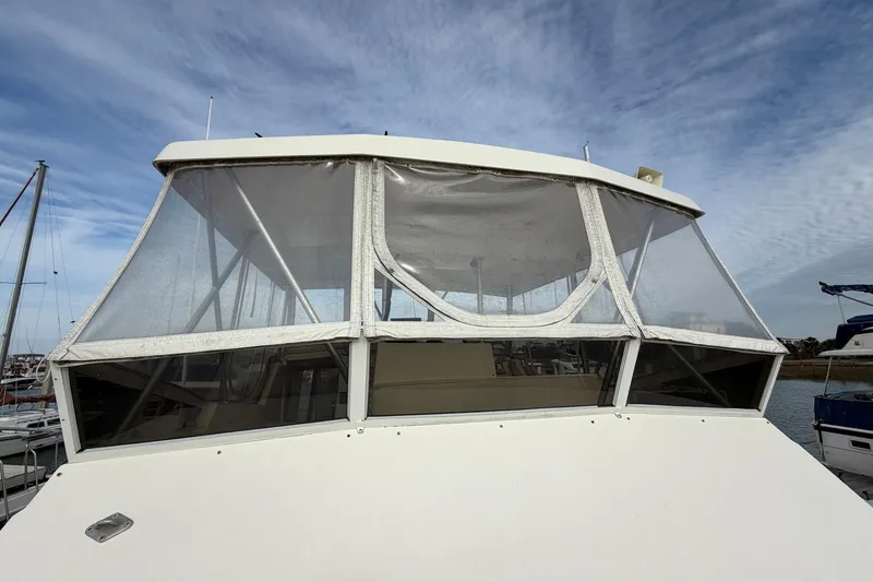 Slide: The Image of 1987 Viking 44 Motor Yacht with enclosed flybridge under a cloudy sky. - 17