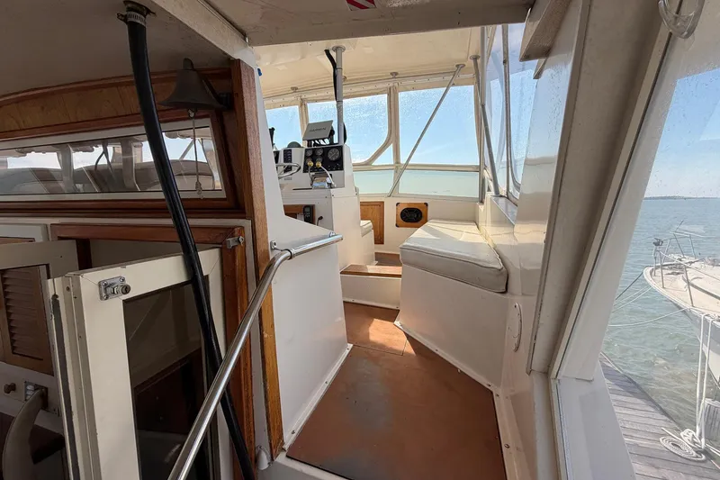 Slide: The Image of 1987 Viking 44 Motor Yacht interior with helm, seating, and ocean view. - 26