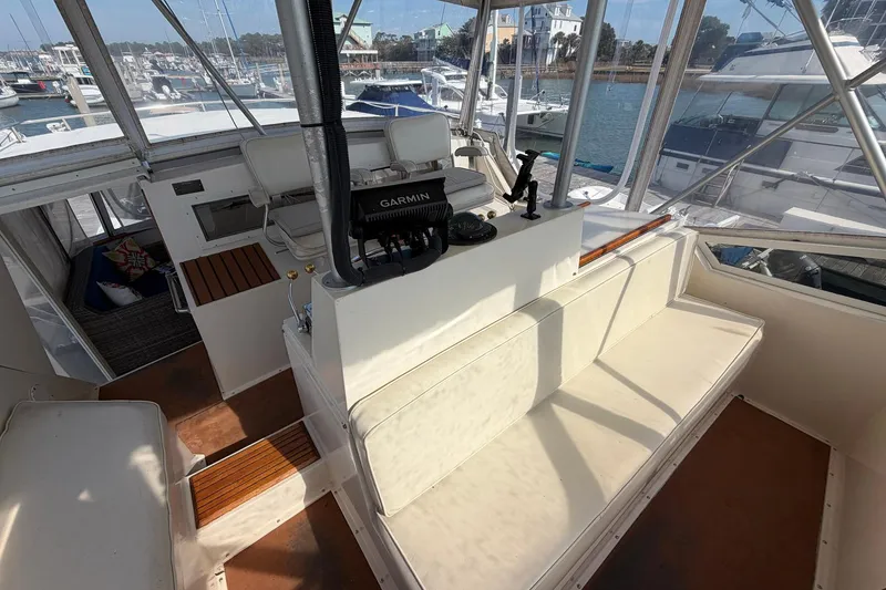 Slide: The Image of 1987 Viking 44 Motor Yacht helm with Garmin navigation, docked in a marina. - 28