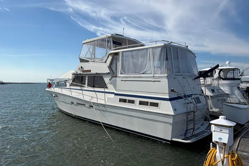 Slide: The Image of 1987 Viking 44 Motor Yacht docked in a marina under a clear blue sky. - 3