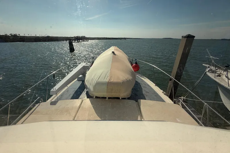 Slide: The Image of 1987 Viking 44 Motor Yacht docked, view from deck with covered equipment. - 30