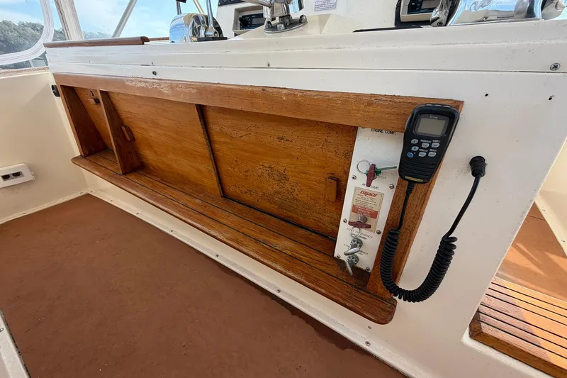Slide: The Image of 1987 Viking 44 Motor Yacht helm with wooden panel and communication device. - 35