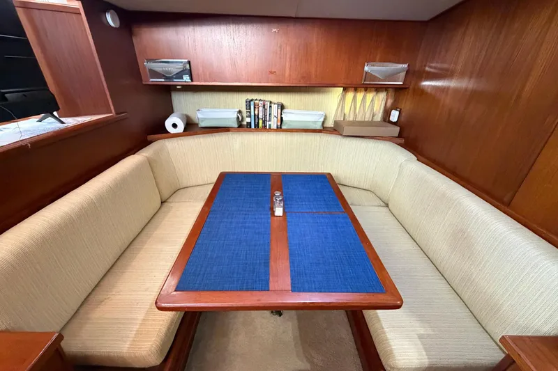 Slide: The Image of 1987 Viking 44 Motor Yacht interior with cozy dining area and wooden accents. - 44