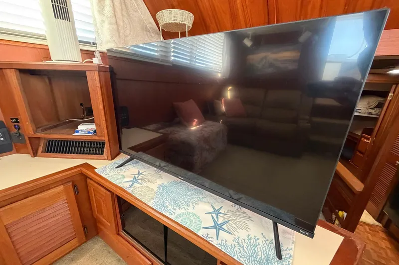 Slide: The Image of Interior of 1987 Viking 44 Motor Yacht with TV and wooden cabinetry. - 45
