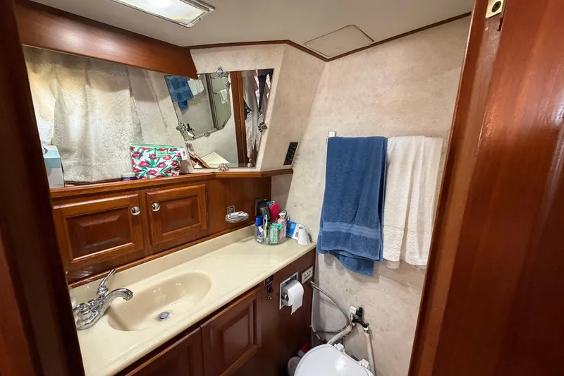 Slide: The Image of Bathroom interior of 1987 Viking 44 Motor Yacht with sink, mirror, and towels. - 59